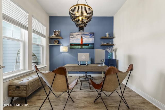 office area featuring a chandelier, baseboards, and wood finished floors