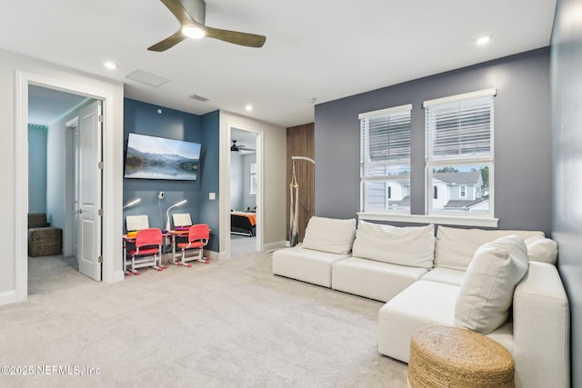 carpeted living room featuring ceiling fan, visible vents, baseboards, and recessed lighting