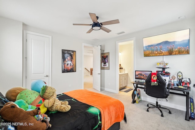 bedroom with connected bathroom, light colored carpet, a ceiling fan, baseboards, and visible vents