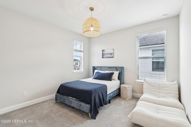 bedroom featuring carpet and baseboards