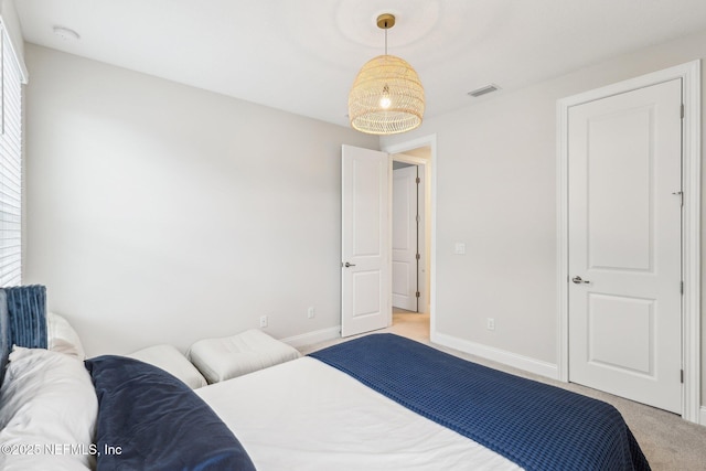 bedroom featuring light carpet, visible vents, and baseboards