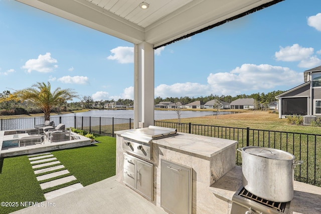 view of patio with a water view, a residential view, fence, and area for grilling