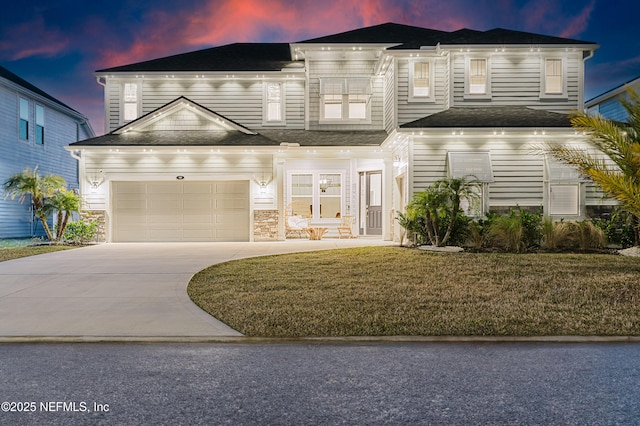 view of front facade with concrete driveway and a front yard