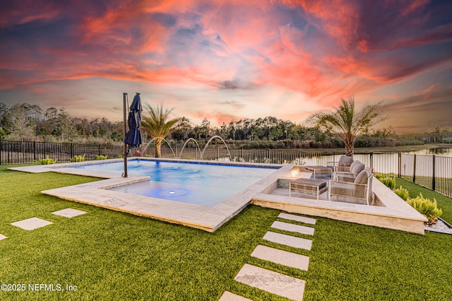 pool at dusk featuring a fenced in pool, a fenced backyard, a yard, and a patio