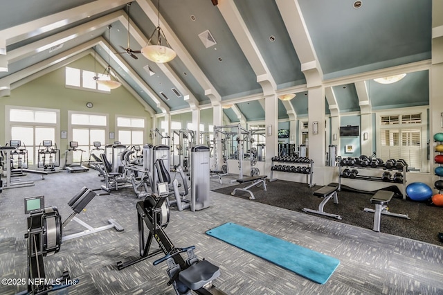 gym featuring high vaulted ceiling, visible vents, and decorative columns