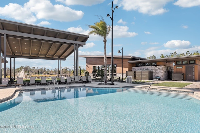 pool with a patio area and fence