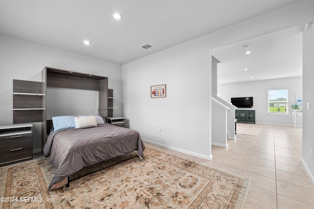 bedroom with light tile patterned floors