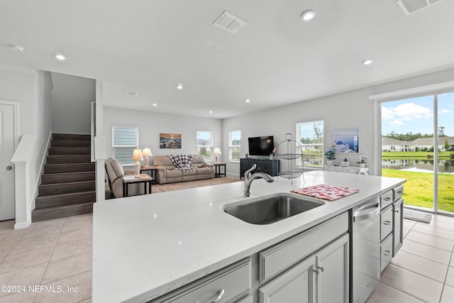 kitchen with light tile patterned flooring, sink, and a wealth of natural light