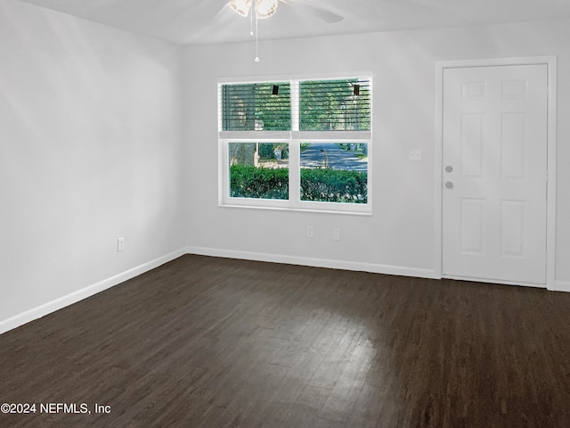 empty room with ceiling fan and dark hardwood / wood-style floors