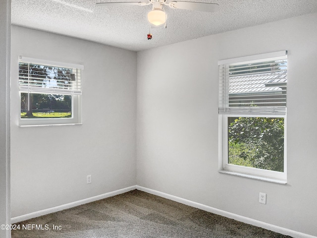 unfurnished room featuring ceiling fan, a textured ceiling, plenty of natural light, and carpet