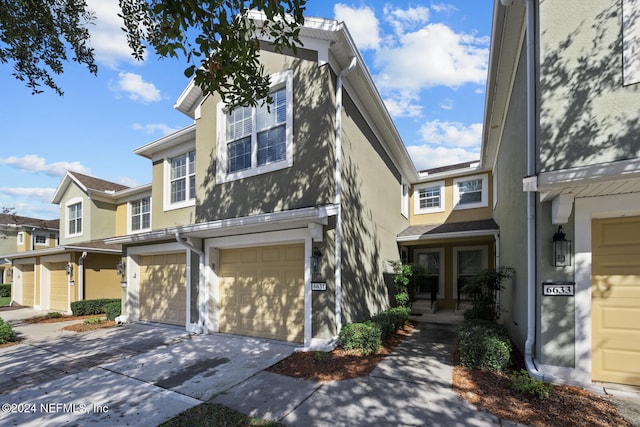 townhome / multi-family property featuring a garage