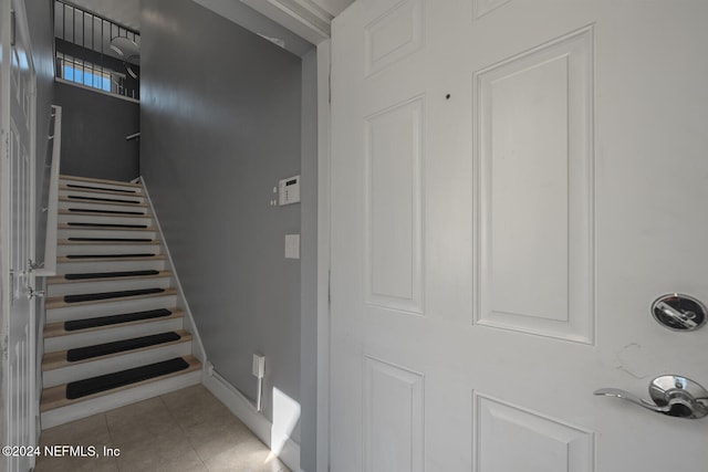 stairway featuring tile patterned floors