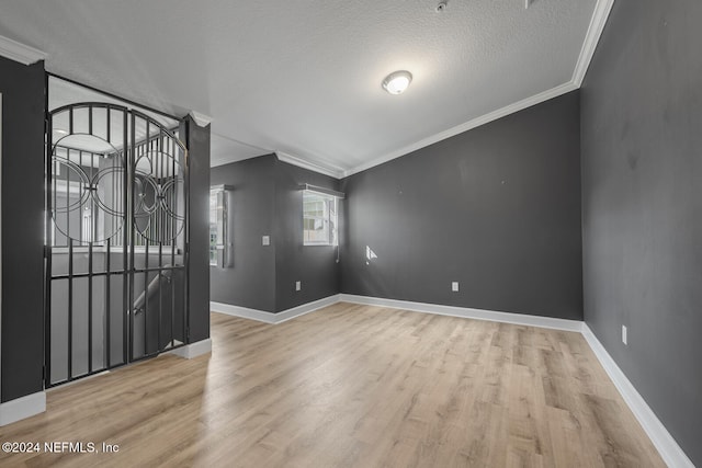 entrance foyer featuring crown molding, light hardwood / wood-style floors, and a textured ceiling