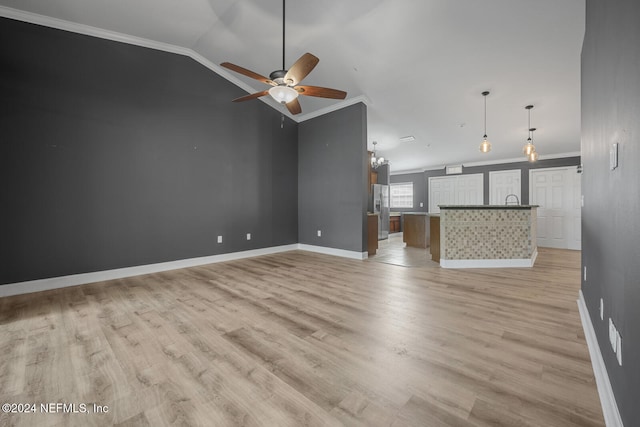 unfurnished living room featuring ceiling fan, light hardwood / wood-style flooring, and ornamental molding