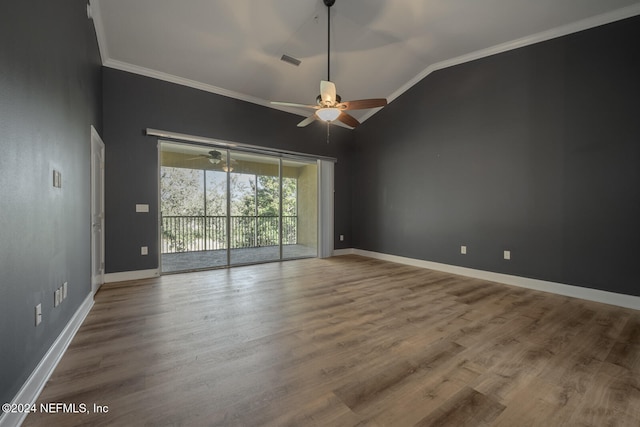 spare room featuring crown molding, wood-type flooring, and vaulted ceiling