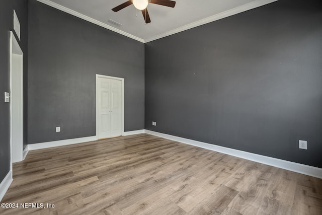 empty room featuring crown molding, ceiling fan, and light hardwood / wood-style floors