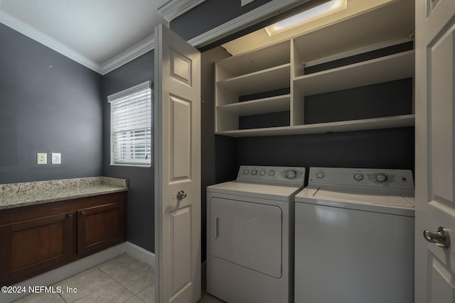 clothes washing area featuring washer and dryer, ornamental molding, and light tile patterned floors