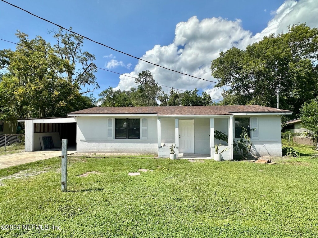 ranch-style home with a front lawn and a carport