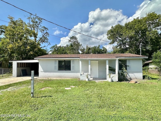 ranch-style home with a front lawn and a carport