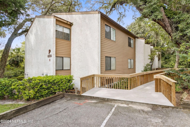 rear view of property featuring a patio area and a deck