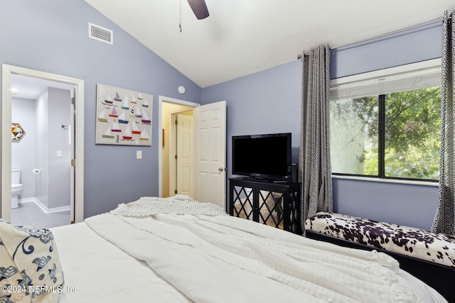 bedroom featuring lofted ceiling, ceiling fan, and ensuite bathroom