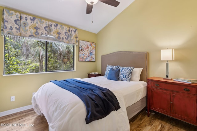 bedroom featuring ceiling fan, hardwood / wood-style flooring, and lofted ceiling