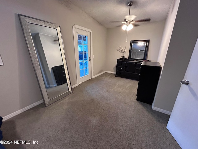 unfurnished bedroom with ceiling fan, carpet floors, and a textured ceiling