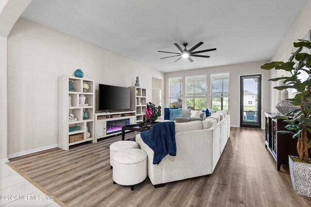 living room featuring ceiling fan and hardwood / wood-style flooring