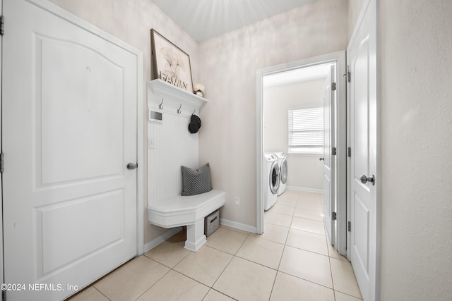 mudroom with washing machine and dryer and light tile patterned floors