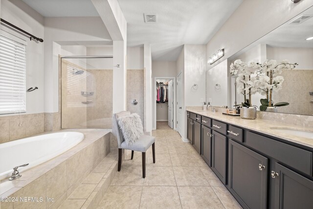 bathroom with vanity, separate shower and tub, tile patterned floors, and a healthy amount of sunlight