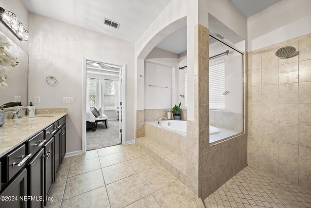 bathroom with vanity, shower with separate bathtub, and tile patterned flooring