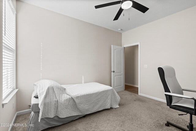 carpeted bedroom featuring ceiling fan