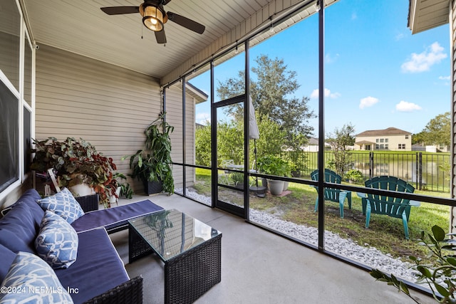 sunroom / solarium featuring ceiling fan