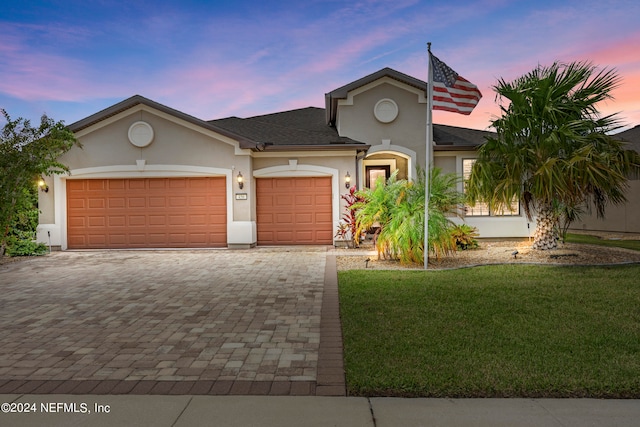 view of front of home featuring a yard and a garage