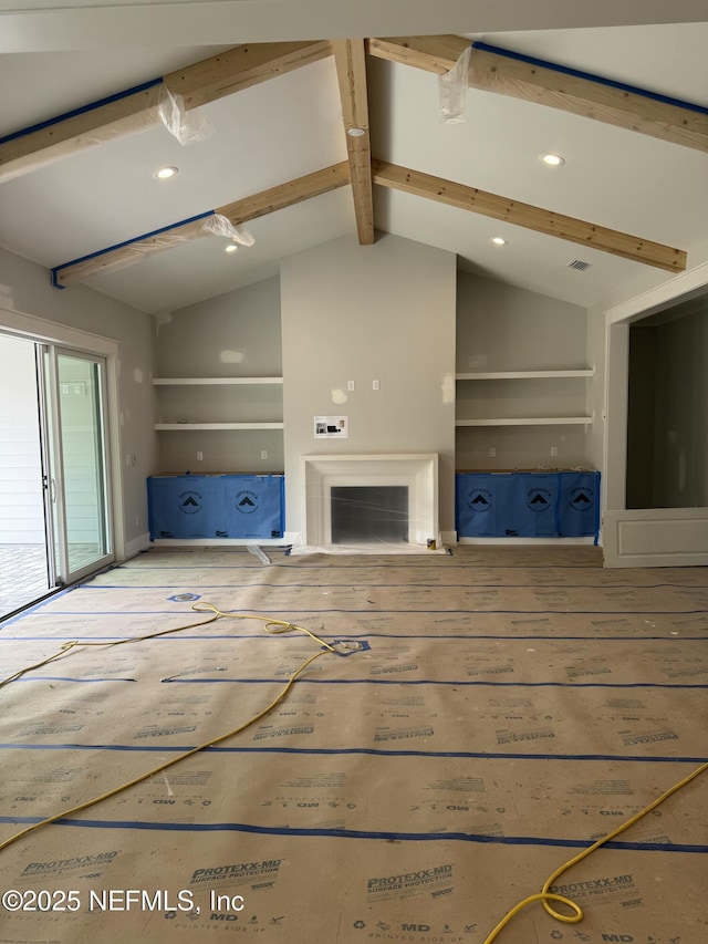 unfurnished living room with wood-type flooring and lofted ceiling with beams