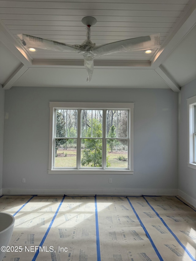 unfurnished room with beam ceiling