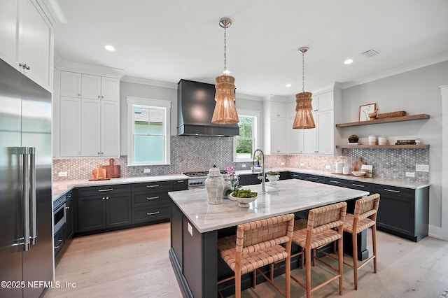 354 River Breeze Dr Lot 3, Ponte Vedra, FL 32081 - kitchen with appliances with stainless steel finishes, wall chimney exhaust hood, light wood-style flooring, crown molding, and white cabinetry