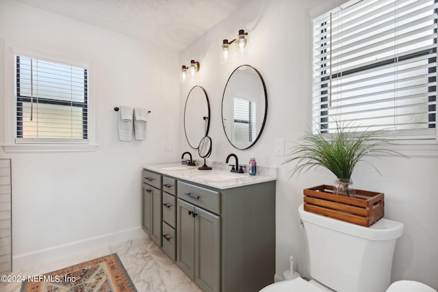 bathroom featuring a textured ceiling, vanity, and toilet