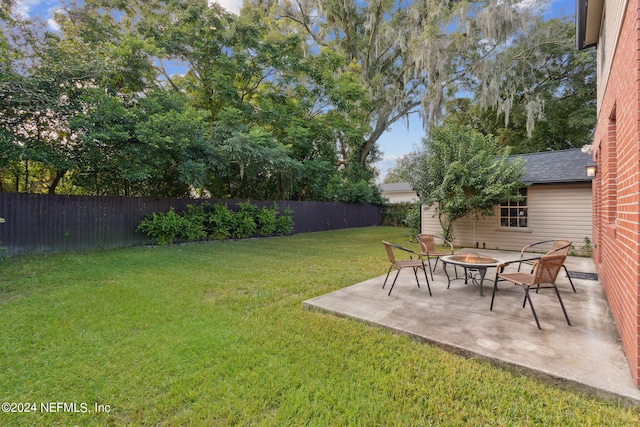 view of yard with a patio and an outdoor fire pit