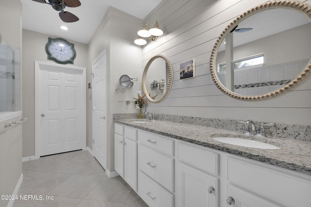 bathroom with vanity, ceiling fan, tile patterned floors, and wooden walls