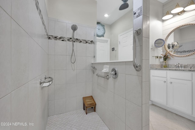 bathroom featuring a tile shower and vanity