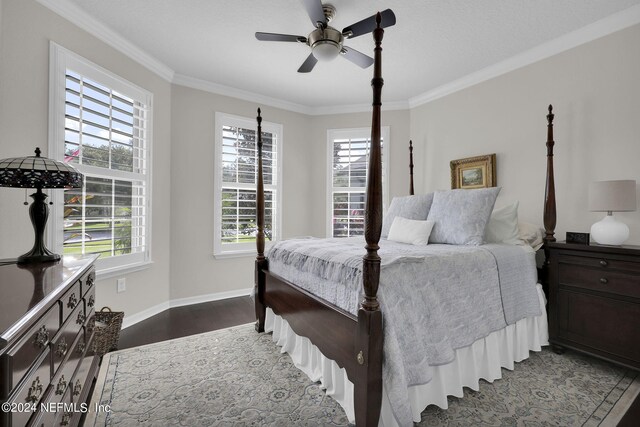 bedroom featuring ceiling fan, crown molding, and multiple windows