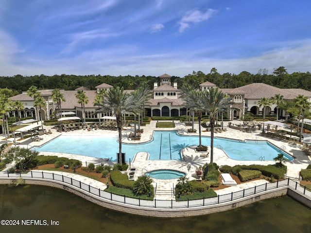 view of swimming pool featuring a hot tub and a patio