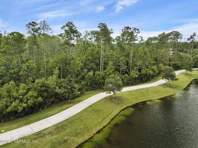 view of community featuring a yard and a water view