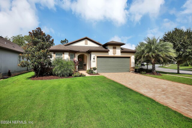 view of front of property with a front lawn and a garage