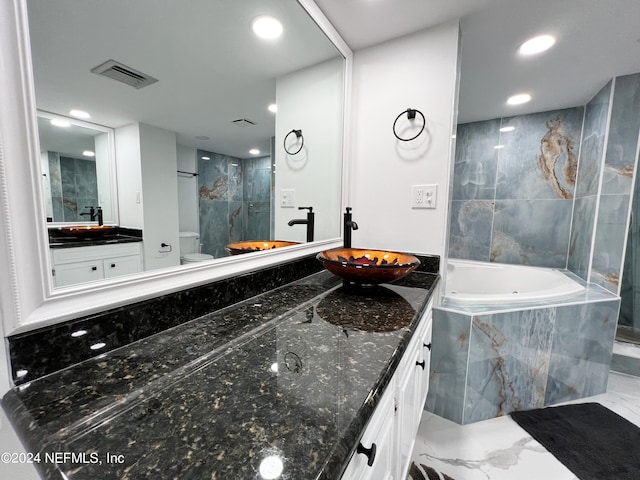 full bathroom featuring separate shower and tub, vanity, and toilet