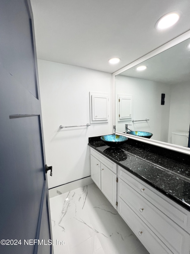 bathroom with vanity and toilet