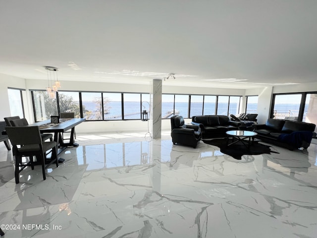 living room featuring plenty of natural light and a water view