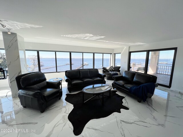 living room featuring a water view and a wealth of natural light