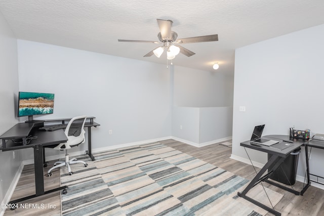 office featuring a textured ceiling, hardwood / wood-style floors, and ceiling fan